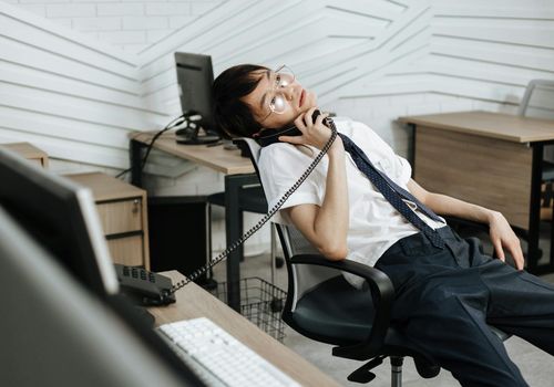 Person sitting at a desk looking tired